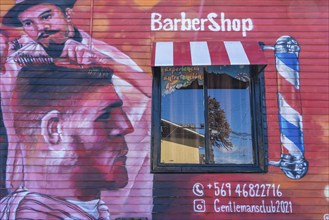 Colourful graffito, street art on the facade of a hairdresser and barber shop, city of Punta