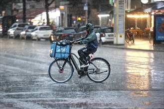 A Volt delivery driver drives along Potsdamer Strasse in the pouring rain. After weeks of heat, the