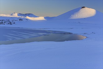 Morning light on a snowy lava field, lake, volcanic crater, snow, winter, Berserkjahraun,