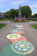 18th century statue of Viana with flower motives on the ground during the Flower festival, Viana do