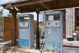 Two old petrol pumps under a wooden roof in a rural setting, Monemvasia, Monemvassia, Monemwassia,