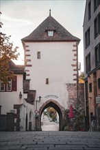 Old town gate surrounded by historic buildings in the old town centre in the morning light, Horb,