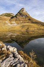 Lake Augstsee and the Atterkogel mountain on the Loser. Autumn, good weather, blue sky. Reflection.