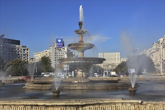 City centre, fountains and skyscrapers at Bulevardul Unirii, behind the Palace of Parliament,