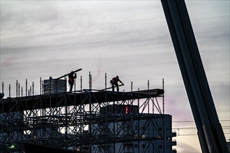 Workers dismantle scaffolding on the Erasmus Bridge over the Nieuwe Maas in Rotterdam, Netherlands