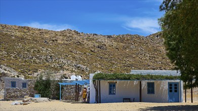 Small rural house under a clear sky in a mountainous setting, Taverna, Psili Ammos Srand, Patmos,