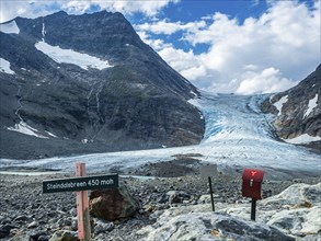 Glacier Steindalsbreen, glacier tongue, signpost and 'trimkassa' at end of valley Steindalen,