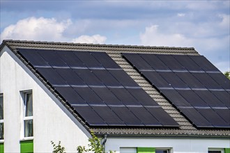 Solar roof, solar panels on a pitched roof of a residential building, renewable energy generation