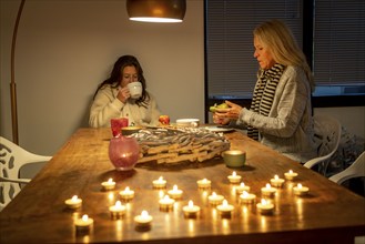 Symbolic image energy saving, cold winter, energy crisis, cold flat, mother and daughter dressed