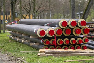 Pipe for district heating connections lying on a construction site on a stockpile, to be laid to