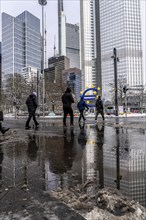 Winter in the city, Gallusanlage street, puddles, pools of water, melt water, pedestrians,