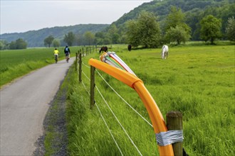 Fibre optic cable, freshly laid along a dirt track, at a paddock, awaiting further expansion,