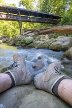 The Irrel Waterfalls, rapids in the lower reaches of the Prüm, covered wooden bridge for hikers,