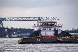 Pushed barge with coal on the Rhine near Duisburg, in the background the NIAG Rhine harbour in