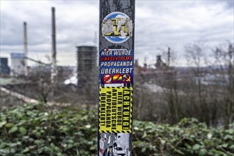 Stickers of right-wing extremist groups pasted over stickers of apparently left-wing groups,