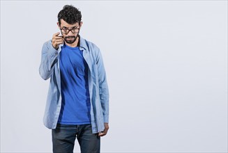 Angry man threatening finger at camera isolated. Concept of angry person threatening head on