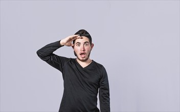 Amazed young man with his mouth open with his hand on his forehead, surprised guy with his mouth