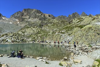 Tourists at the Lac Blanc mountain lake, Aiguilles Rouges nature reserve, Chamonix, Haute Savoie,