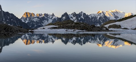 Morning atmosphere, mountain landscape at sunrise, water reflection in Lac Blanc, mountain peak,