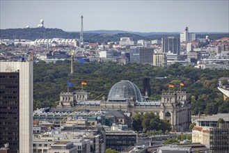 View of Reichstag with German flag, radio tower and ICC trade fair centre. City view. Berlin,