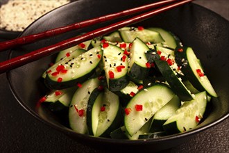 Chinese salad, cucumbers with chili pepper and sesame seeds, homemade, no people