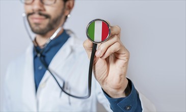 Doctor holding stethoscope with Italy flag. Italian Health and Care Concept, Italy flag on