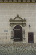 Entrance Protestant castle church, gate, wooden door, information board, writing, letters, masonry,