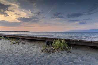 Wooden jetty on a quiet sandy beach in Nin at dusk with the sea, Pag, Zadar, Croatia, Europe