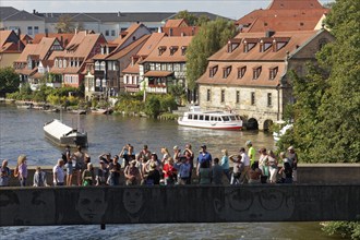 Tourists looking at the town hall, standing on the town hall bridge on the river Regnitz, Little