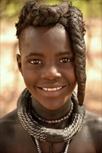 Smiling Himba girl with typical hairstyle, Omuramba, Kaokoland, Kunene, Namibia, Africa