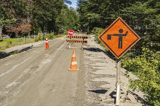 Construction work on the Carretera Austral road, stop sign, gravel road, forest north of Caleta