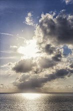 Sunset over the sea with the sun rays through the clouds, Malaysia, Asia