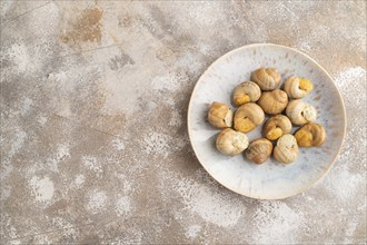 Grape (Burgundy) snails with butter and cheese on brown concrete background. Top view, flat lay,