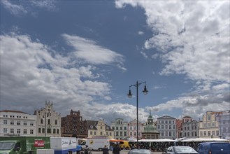 Weekly market on the market square, behind historic residential and commercial buildings, Wismar,