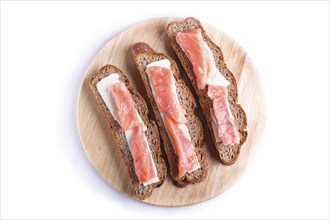 Smoked salmon sandwiches with butter on wooden board, isolated on white background. close up