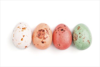 Four chocolate eggs candies isolated on white background. close up, top view, flat lay