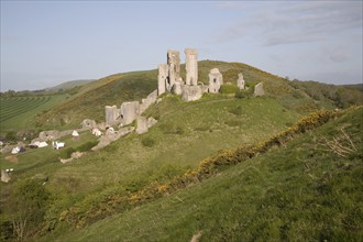 Corfe Castle is located in a natural defensive site on a hill between chalk ridges and for a