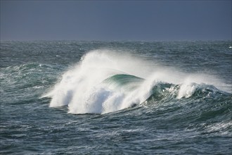 Big wave breaks in the open sea on the Breton coast near Brest, France, Europe