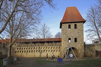 Historic town fortifications with pigeon tower and children's playground, town wall with