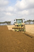 John Deere green tractor ploughing field, Shottisham, Suffolk, England, United Kingdom, Europe