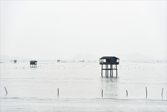 Traditional wooden huts of fishermen in the Gulf of Thailand in the morning haze, fisherman,