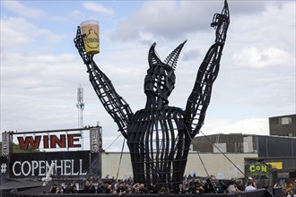 Copenhagen, Denmark - 19 June 2024: Festivalgoers in front of the logo at the Copenhell Metal