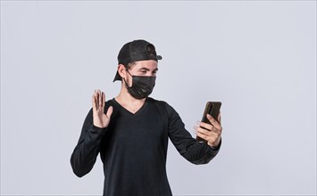 Man making video call isolated, guy making video call with face mask, face mask video call concept