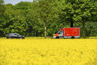 Landscape on the Lower Rhine, ambulance on the B57 federal road between Xanten and Kalkar, road