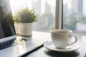 Cup of coffee on table next to laptop. KI generiert, generiert, AI generated