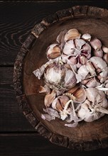 Fresh garlic, in a wooden plate, top view, close-up, no people