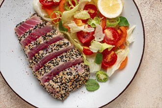 Fillet of red tuna meat, fried in sesame seeds, homemade, close-up, no people, on a wooden