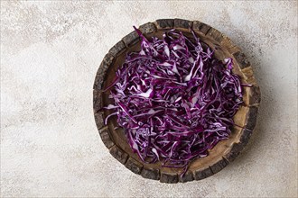 Red cabbage, sliced, in a wooden salad bowl, top view, no people