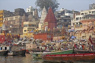 Holy city and colourful rowing boats on the Ganges river at Varanasi, Uttar Pradesh, India, Asia