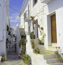 Narrow alley in the white village of Frigiliana, Axarquia mountains region, Malaga province,